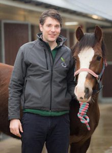 Tom Witte standing with a pony at Oaklands Veterinary Centre